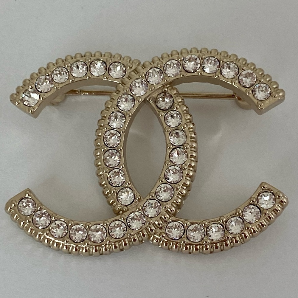 Chanel iconic authentic brooch with pave’ crystals.
